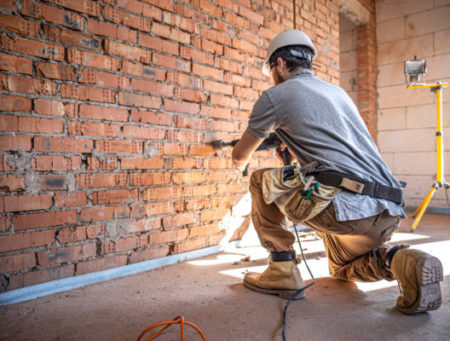 handyman-construction-site-process-drilling-wall-with-perforator